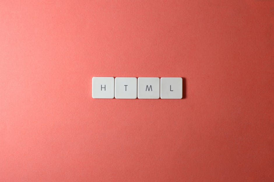 A close-up image showing four white square tiles arranged in a horizontal line on a pink background. Each tile has a single black letter, spelling out 'HTML'. The surface of the tiles appears smooth a